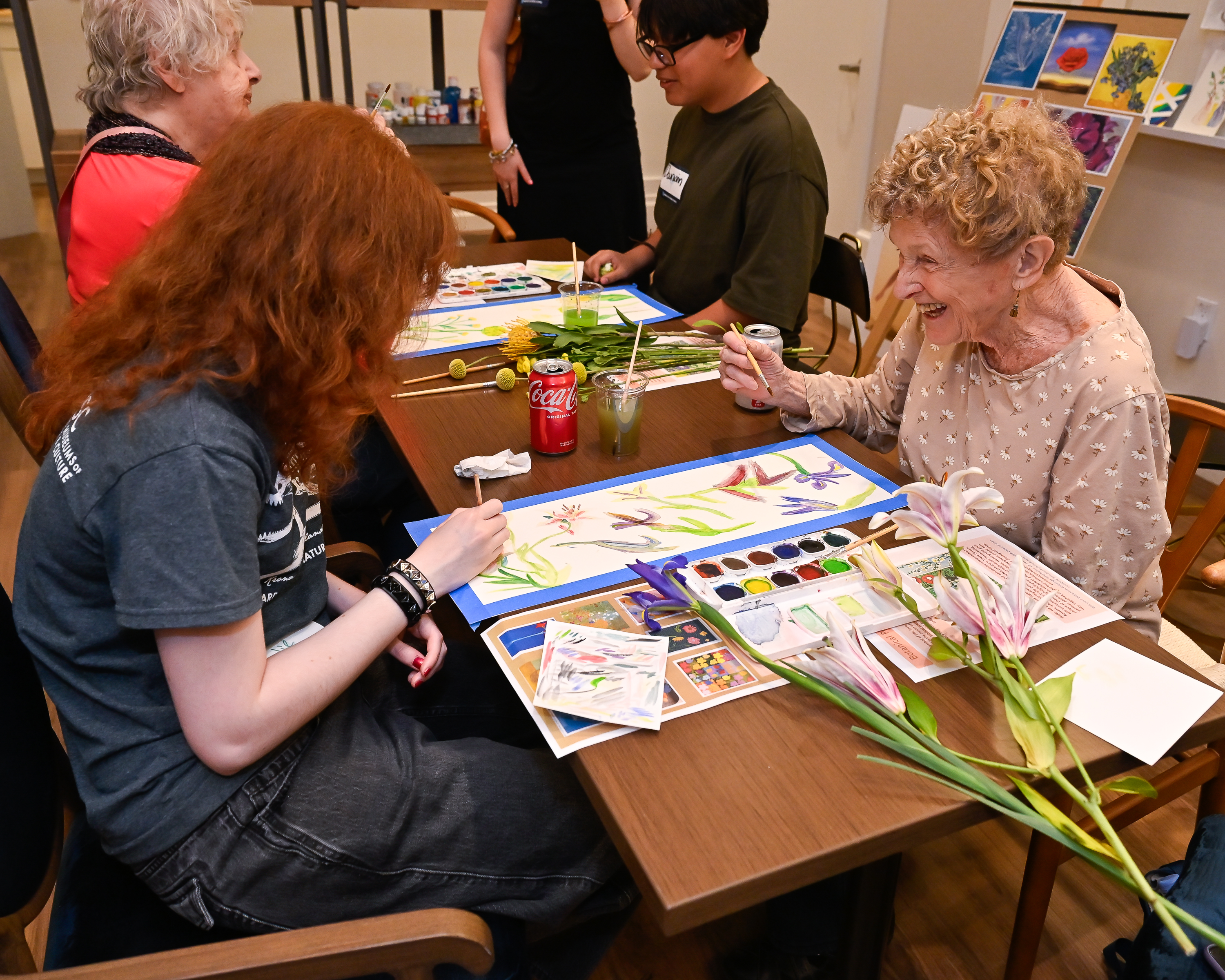 people at a table working on art