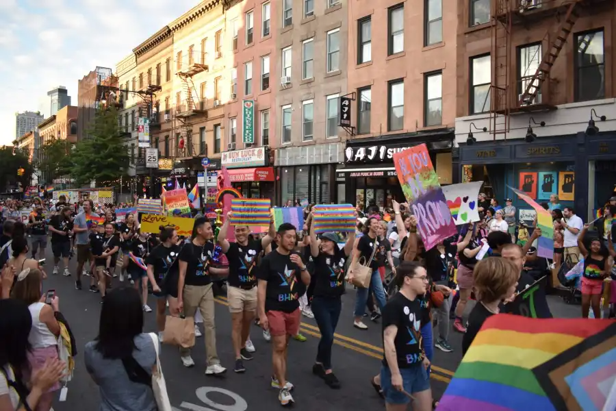 crowd marching and holding signs and flags