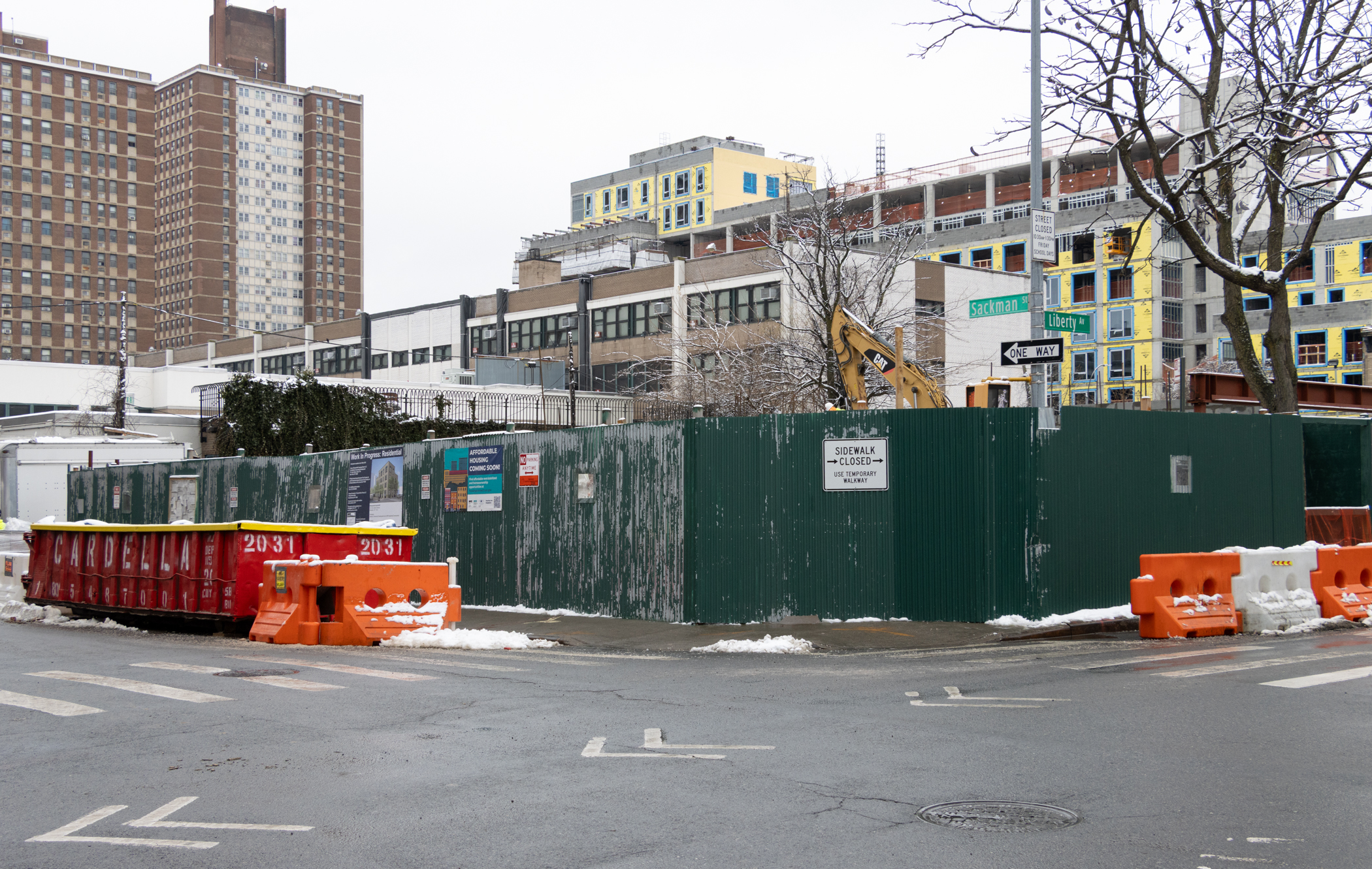 green construction fence around a building site