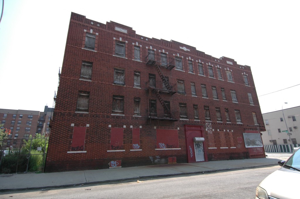 large vacant brick building on corner lot