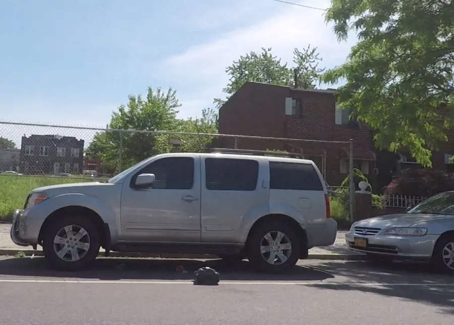 a vehicle parked in front of an empty lot