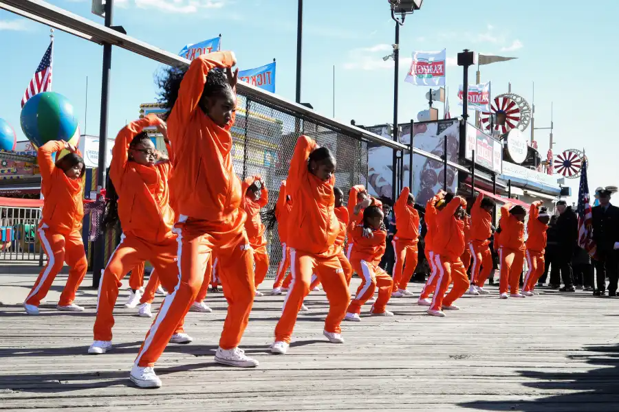 dancers in orange outfits