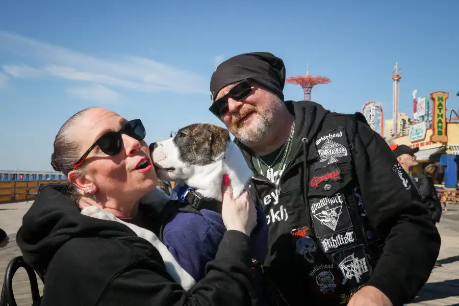 people posing with a dog