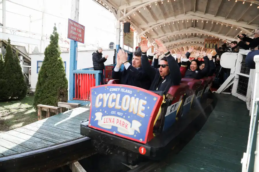 people in a roller coaster car