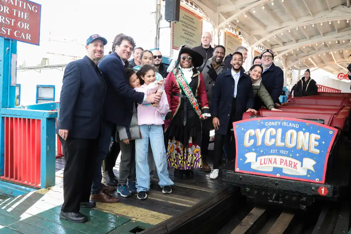 people posing in front of the cyclone
