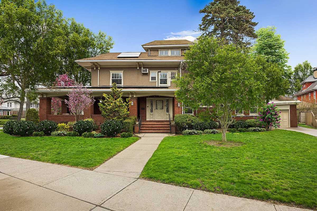 house with brick porch and broad lawn
