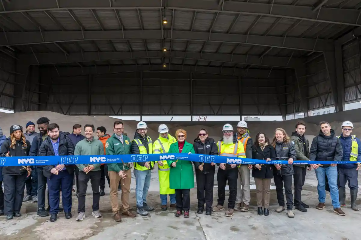 group of people cutting a blue DEP ribbon