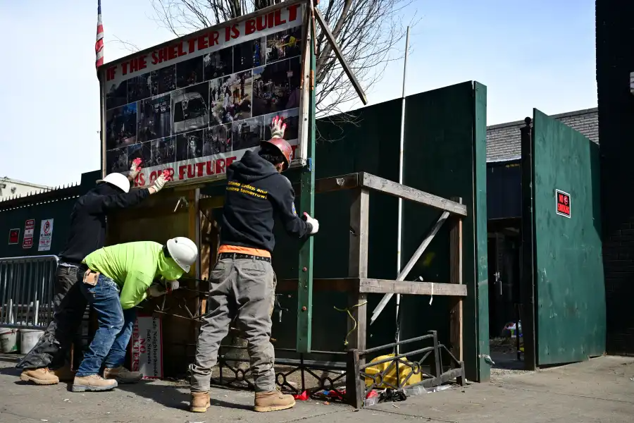 construction workers removing a sign