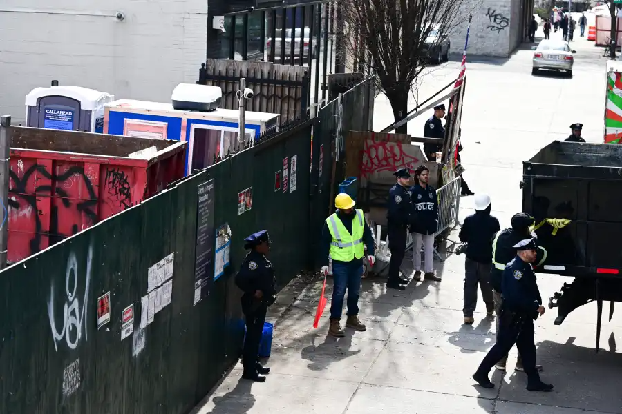 construction workers at a construction fence
