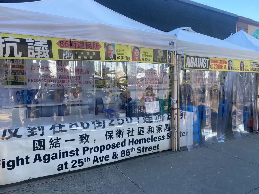 a tent with protest signs