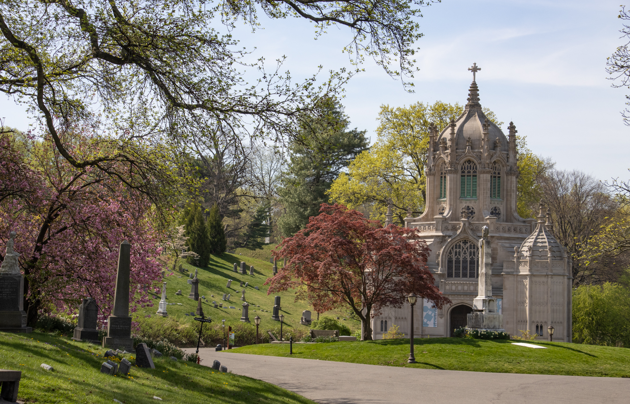 green-wood cemetery chapel surrounded by spring trees