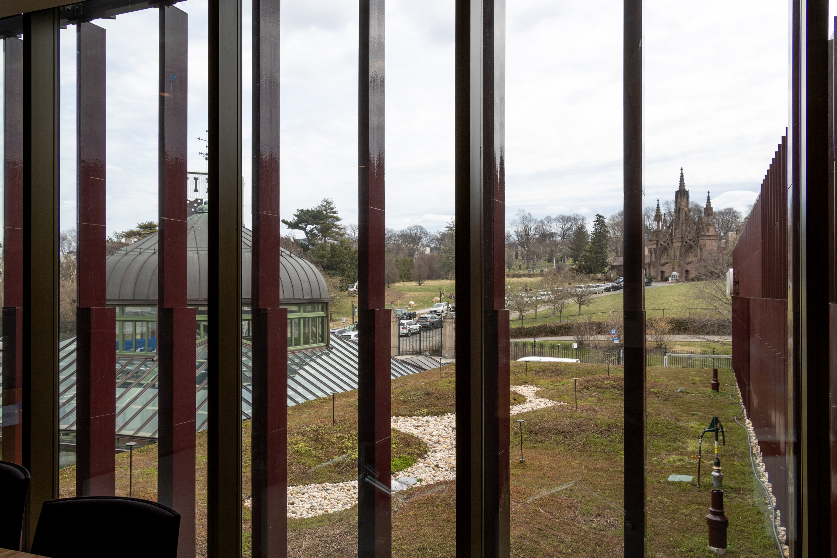 board room interior with view of the main brownstone gates of the cemetery