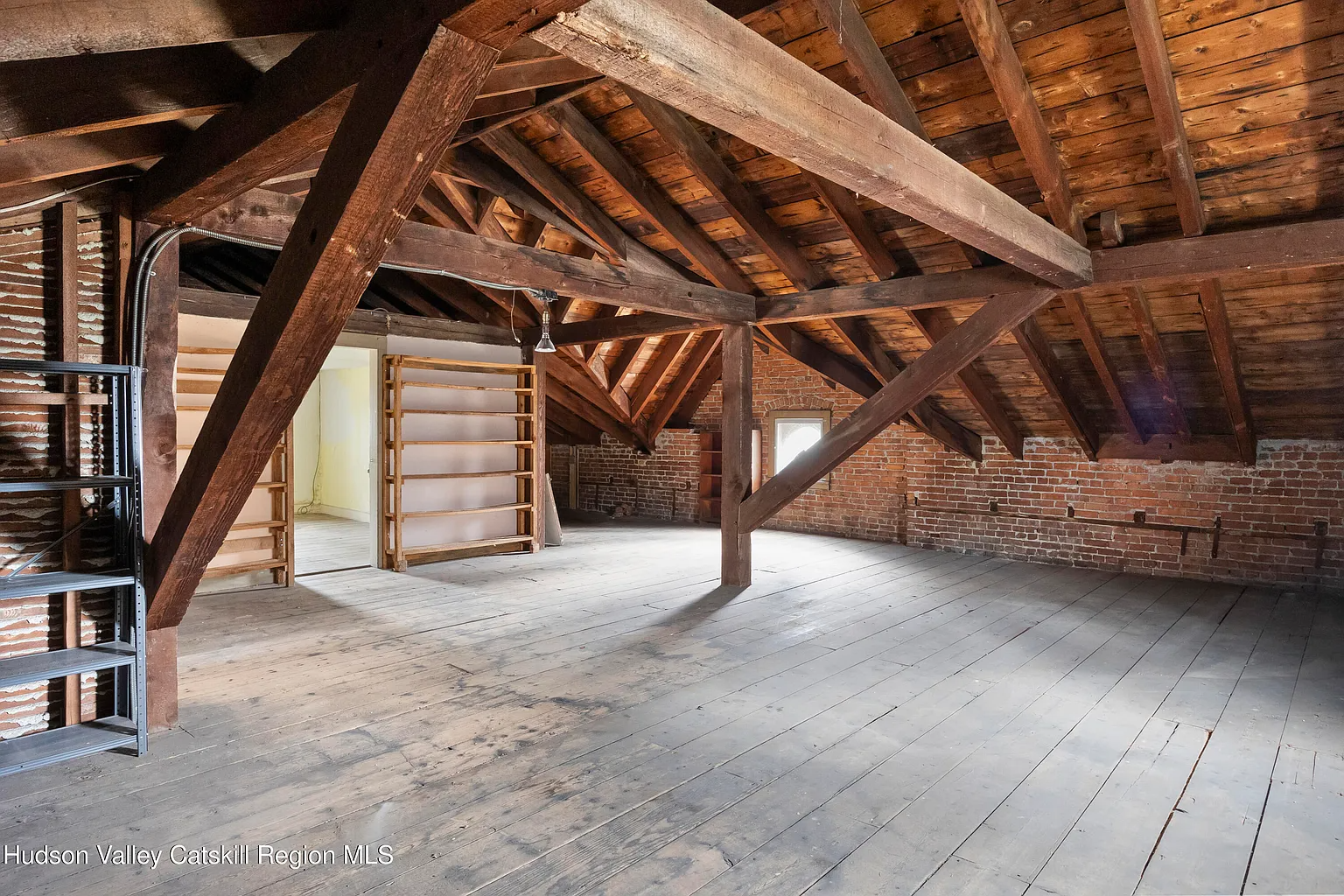 attic with exposed rafters, brick