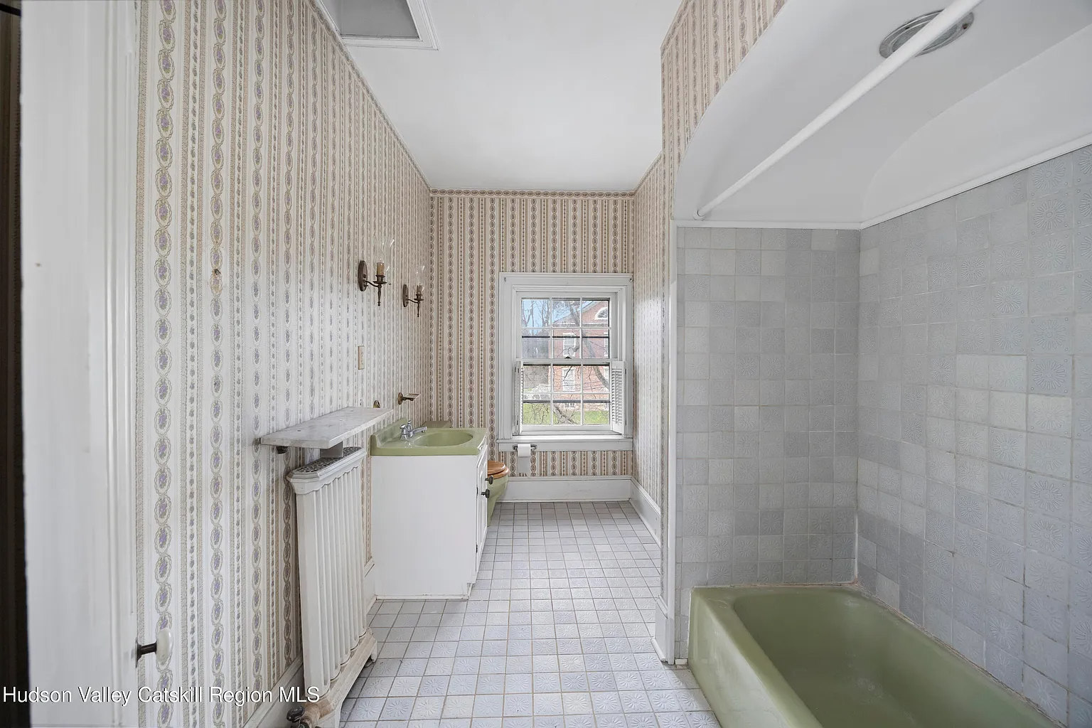 bathroom with green sink and tub