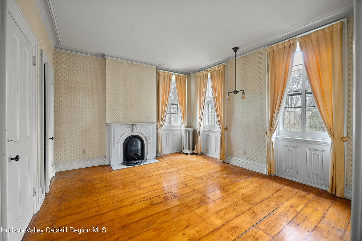 bedroom with two exposures, marble mantel, wood floor