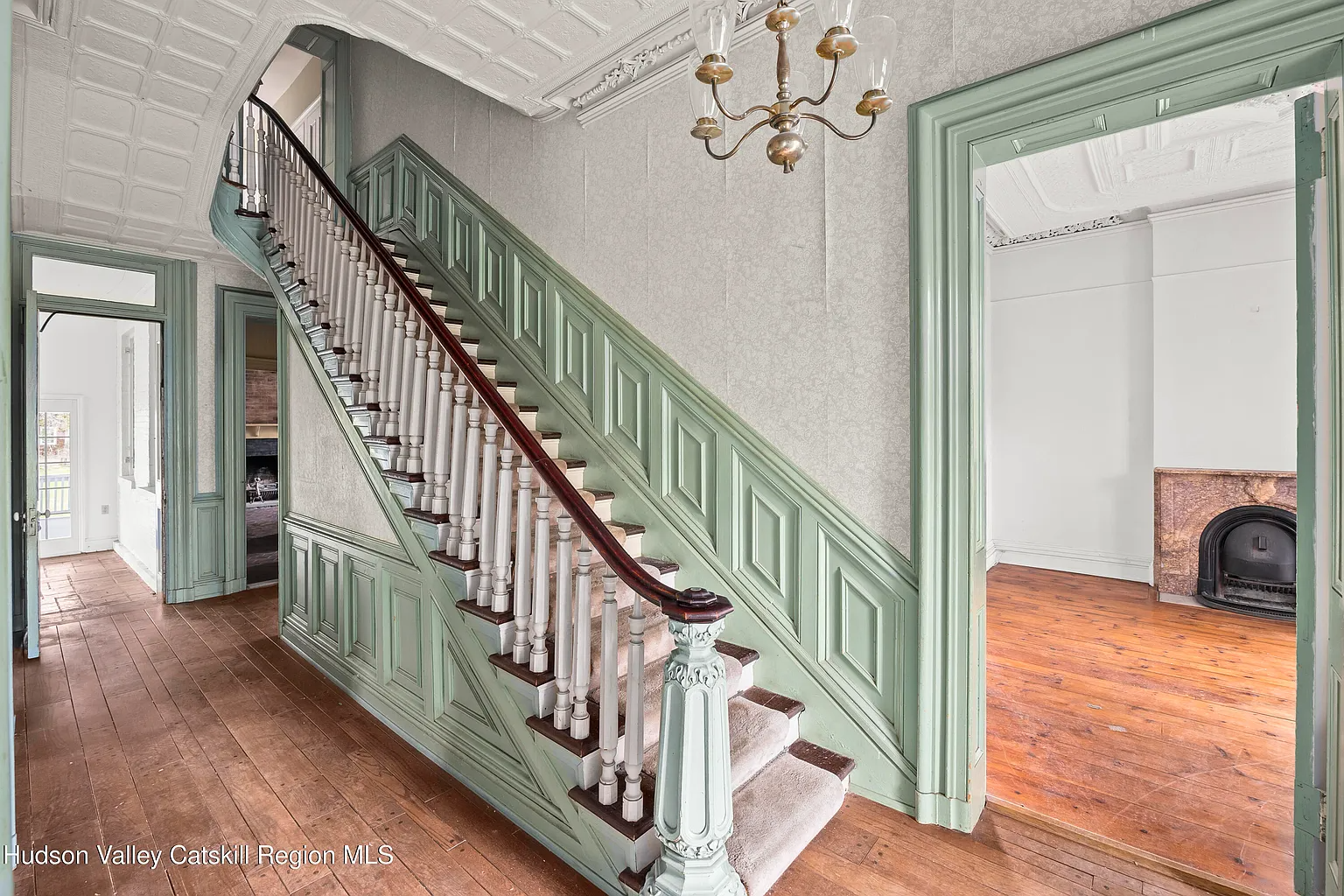 entry hall with woodwork painted green