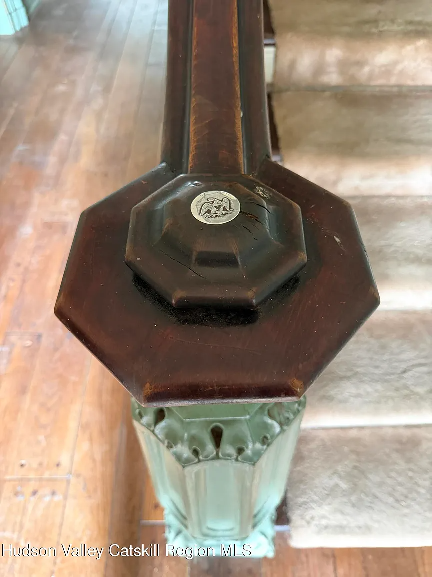 newel post with a coin in the center
