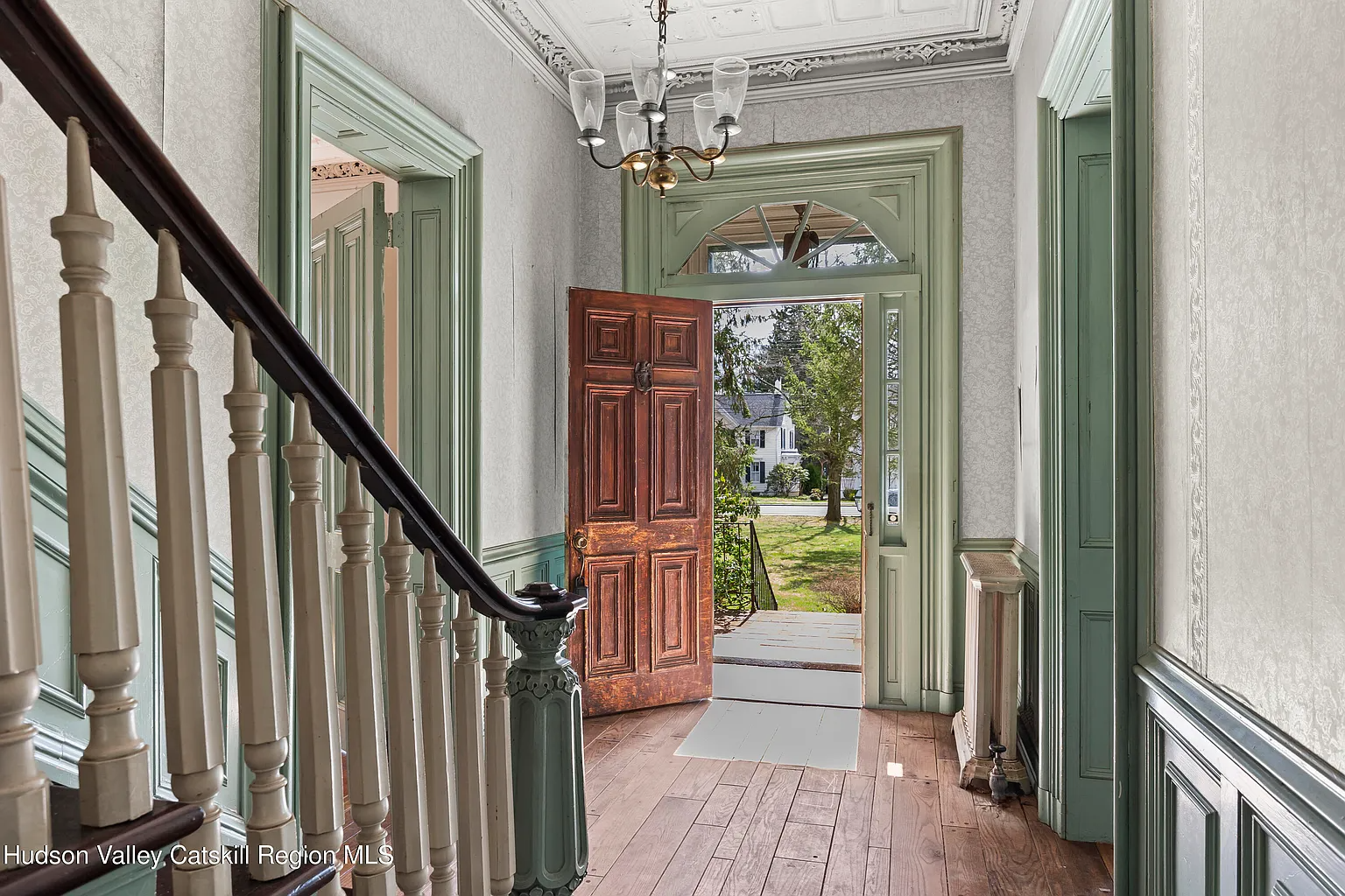 entry hall with green woodwork, stair