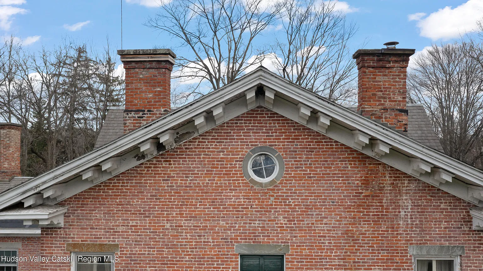 a bulls eye window on a brick house