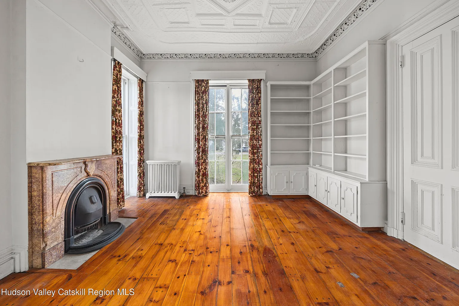 parlor with marble mantel, wide planked floor boards