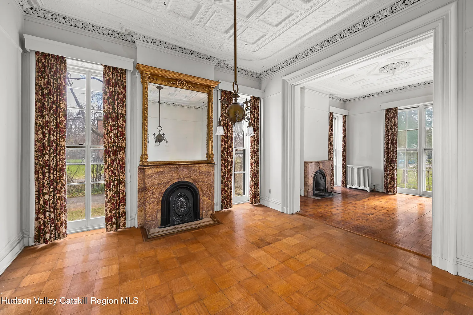 parlor with marble mantels, tin ceiling, plasterwork