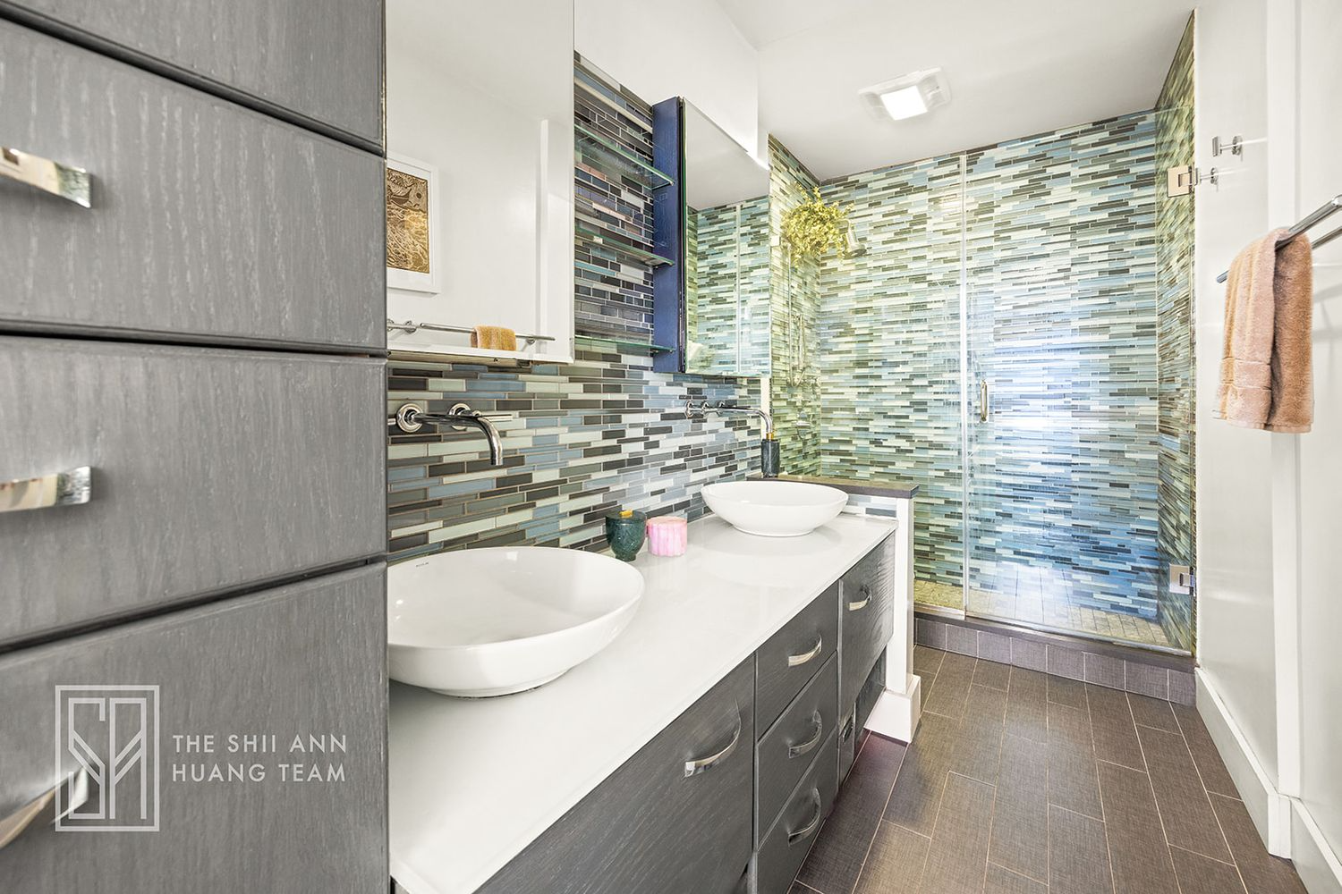 bathroom with double vanity, large walk-in shower