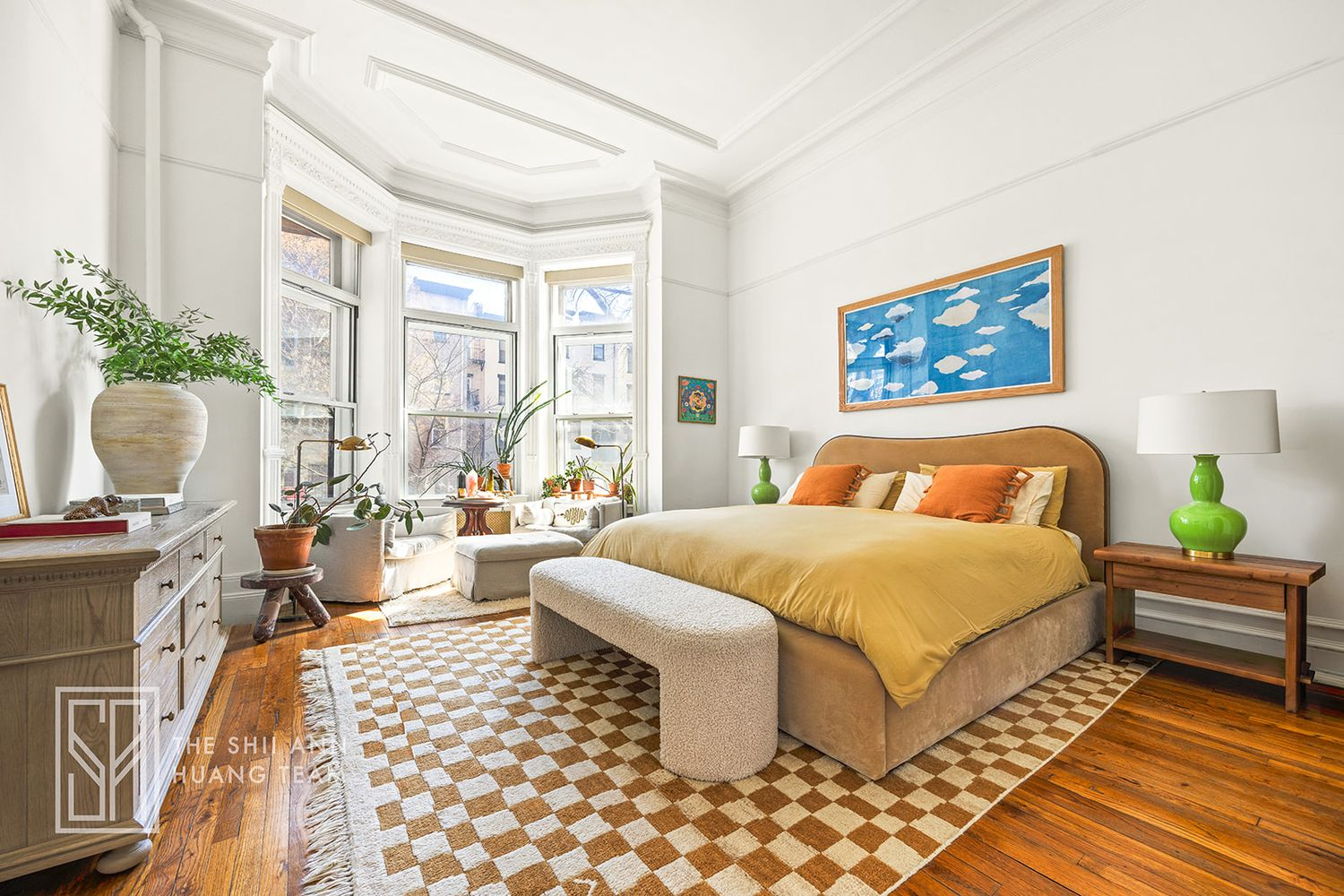 bedroom with bay window, wood floor, picture rails