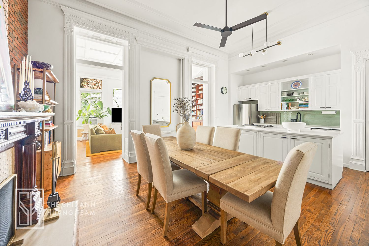open plan kitchen and dining room with a mantel