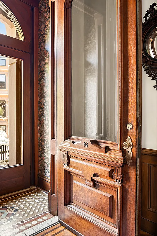 vestibule with tile floor, floral wallpaper