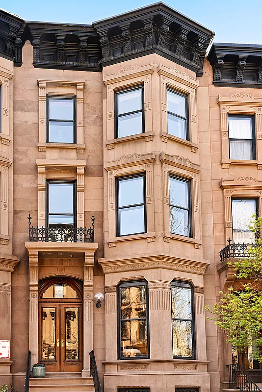 brownstone exterior with stoop, bracketed cornice