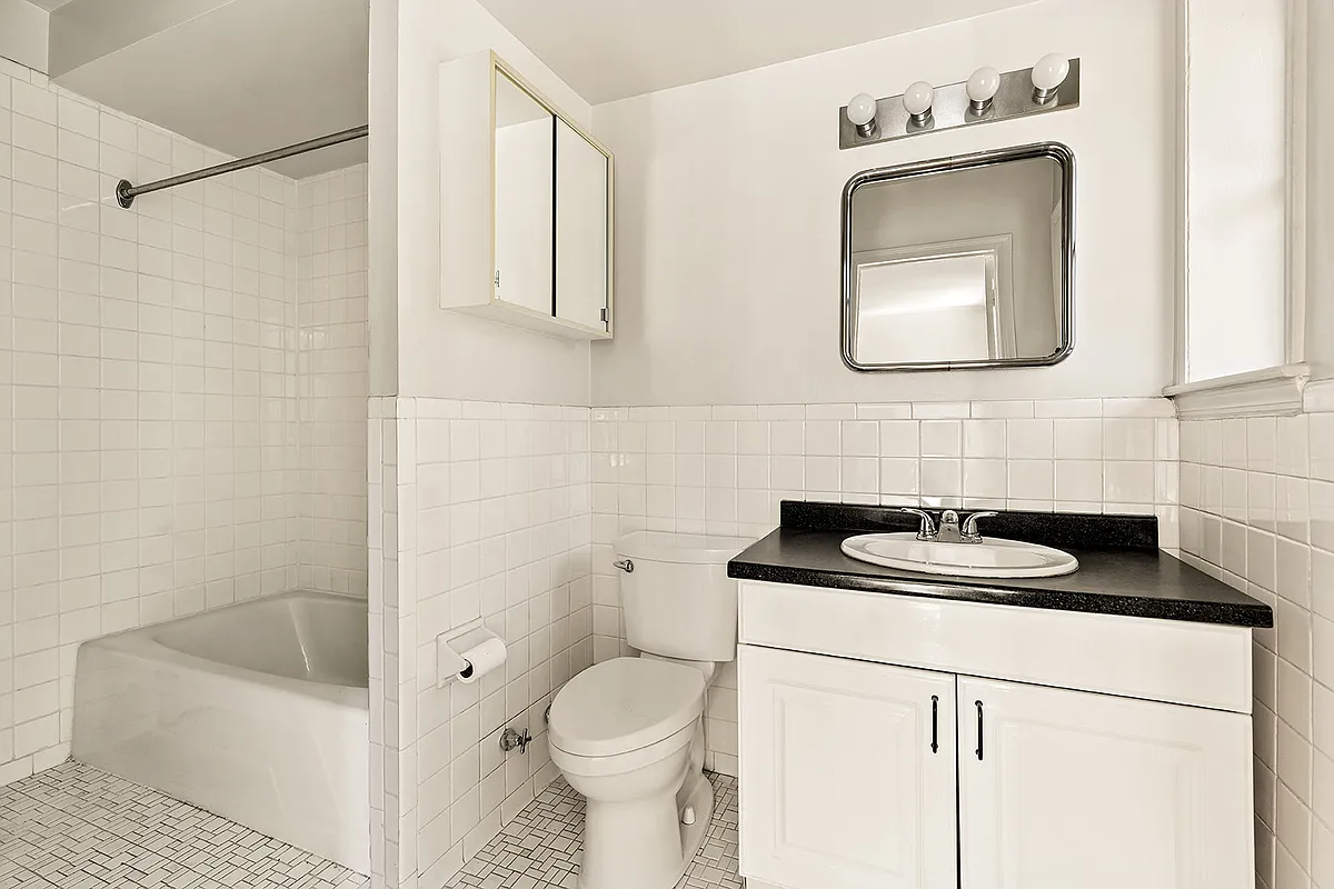 garden level apartment with white fixtures, wall tile