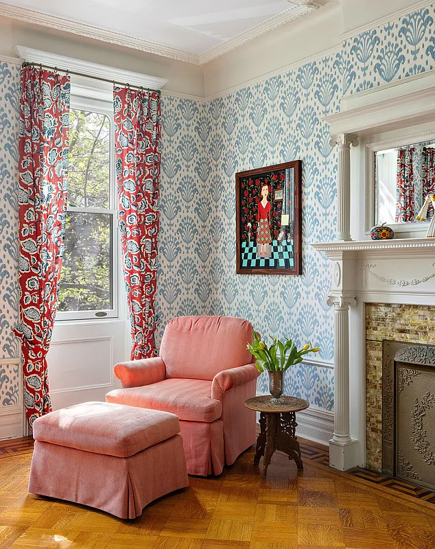 bedroom with blue and white wallpaper, a mantel