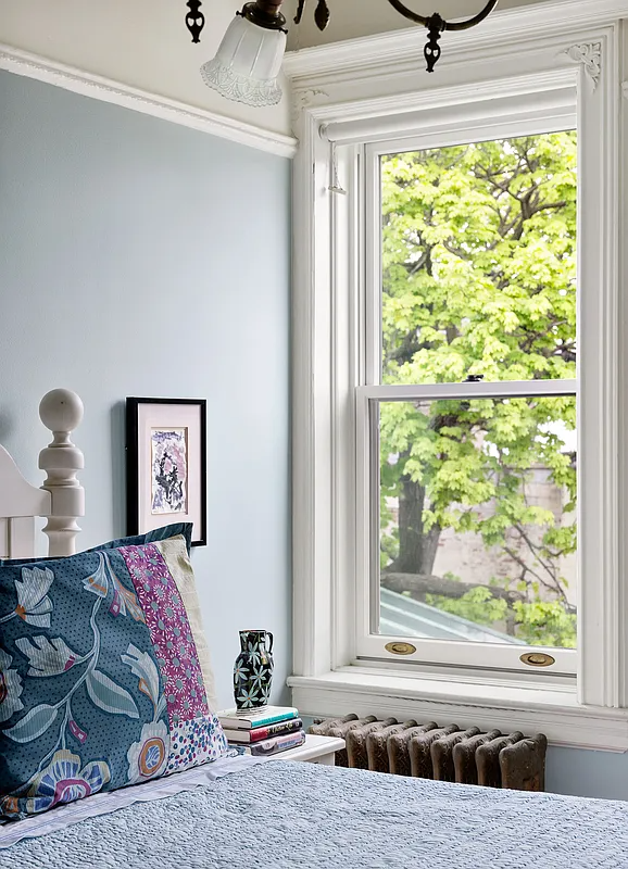detail of white molding around bedroom window