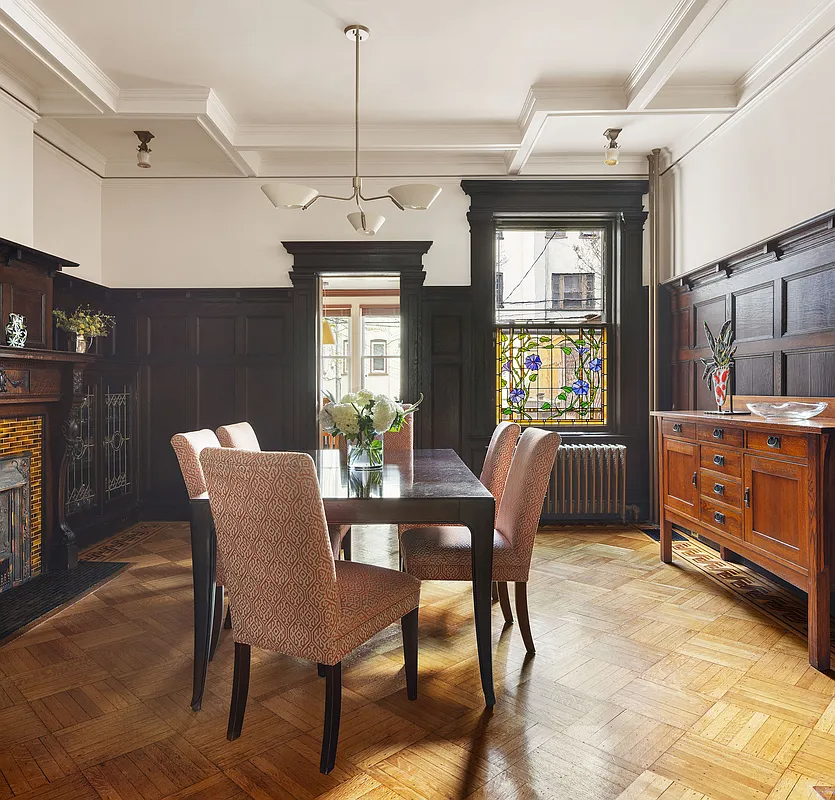 dining room with wainscoting, built-in bookcases