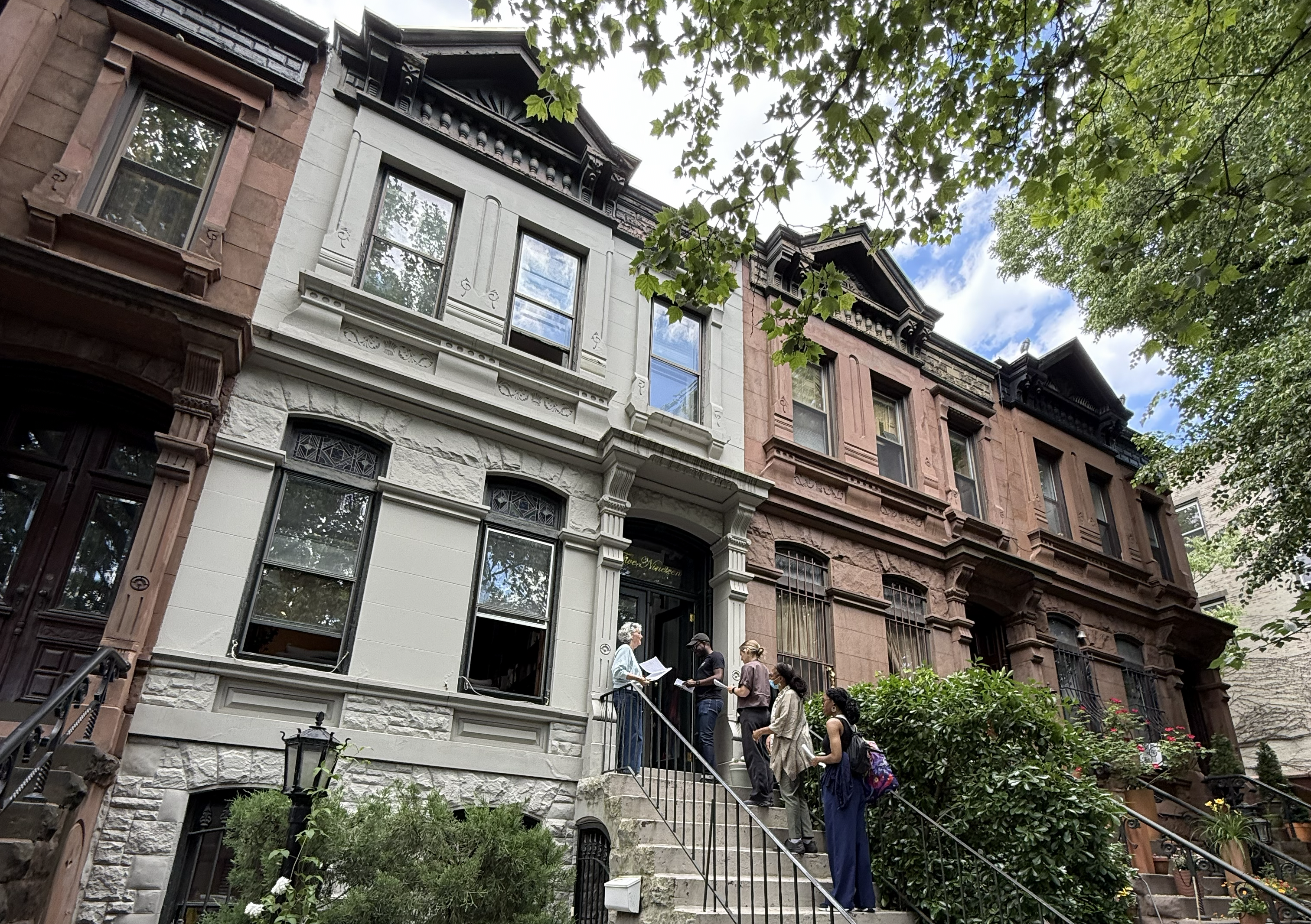 people on a stoop for a tour