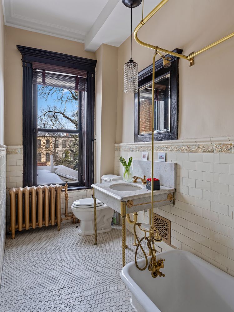 bathroom with a marble sink, vintage subway tile and a white tub