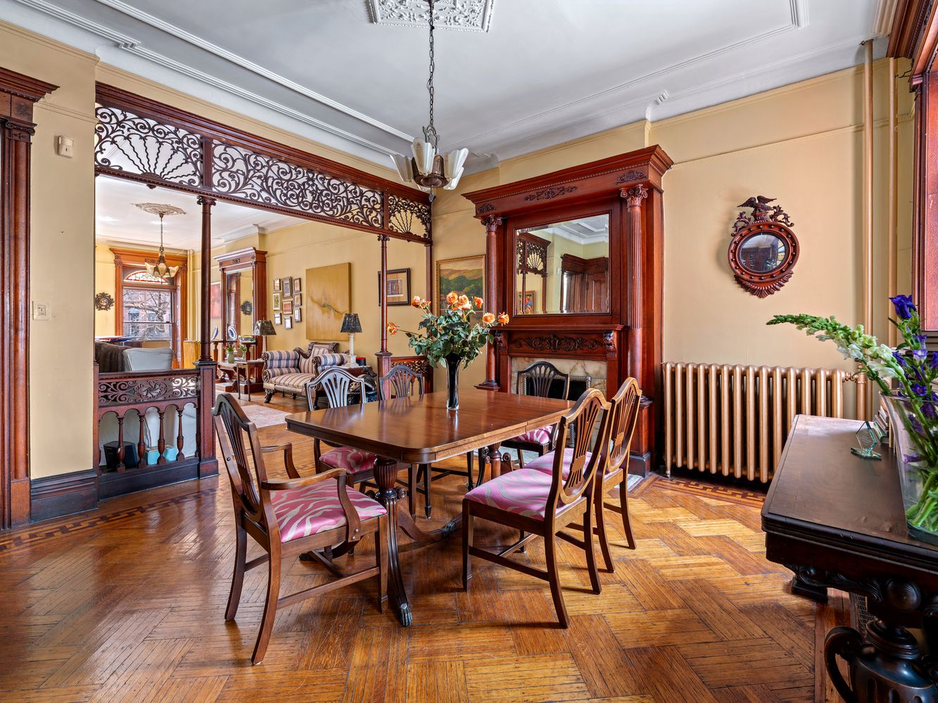 dining room with a columned wood mantel, fretwork, and a ceiling medallion