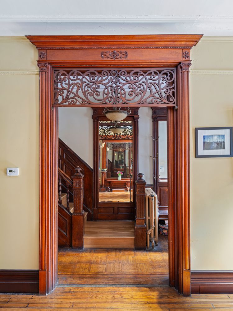 fretwork in the doorway between the entry and the parlor