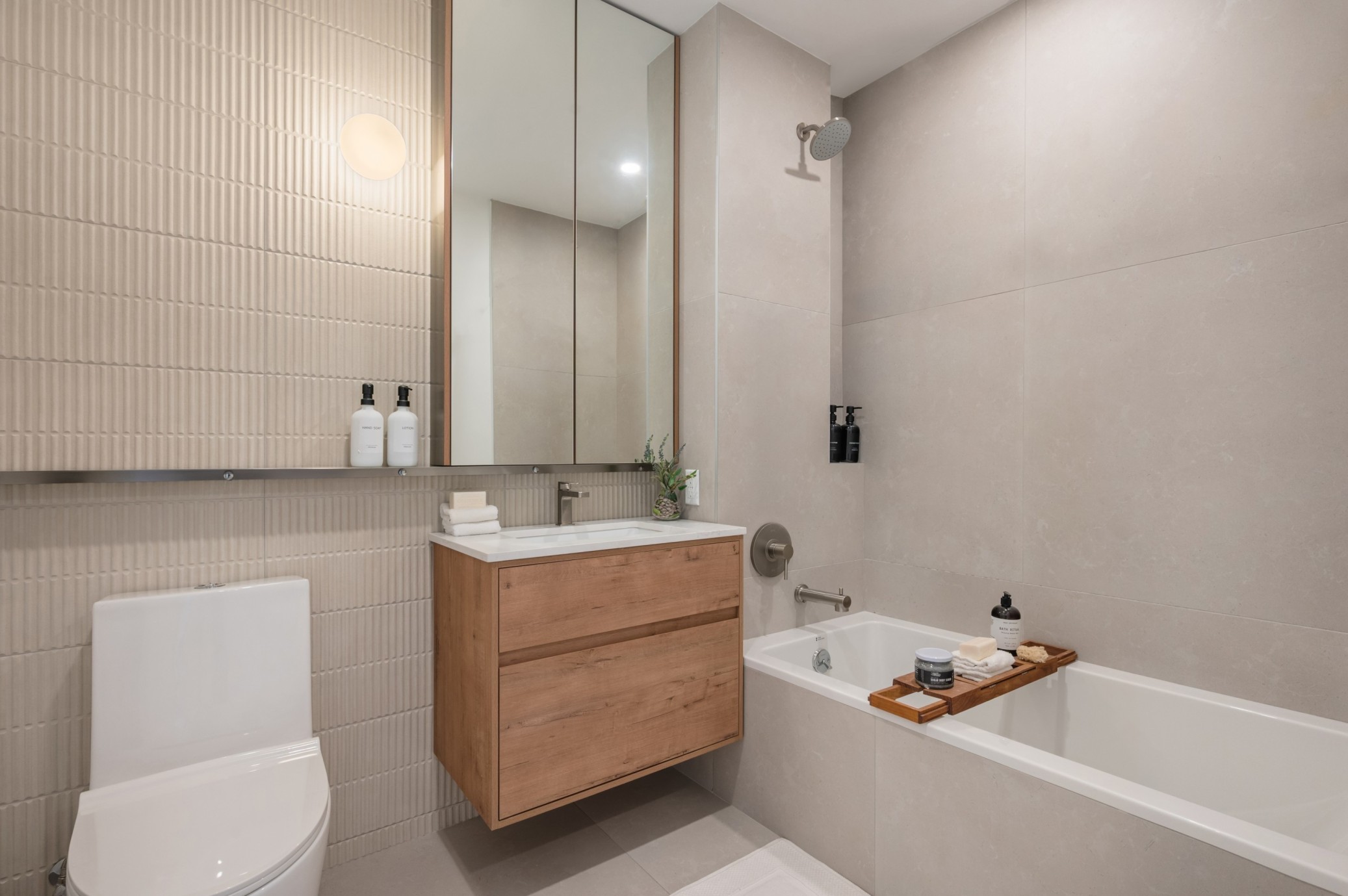 bathroom with floating vanity, beige tile