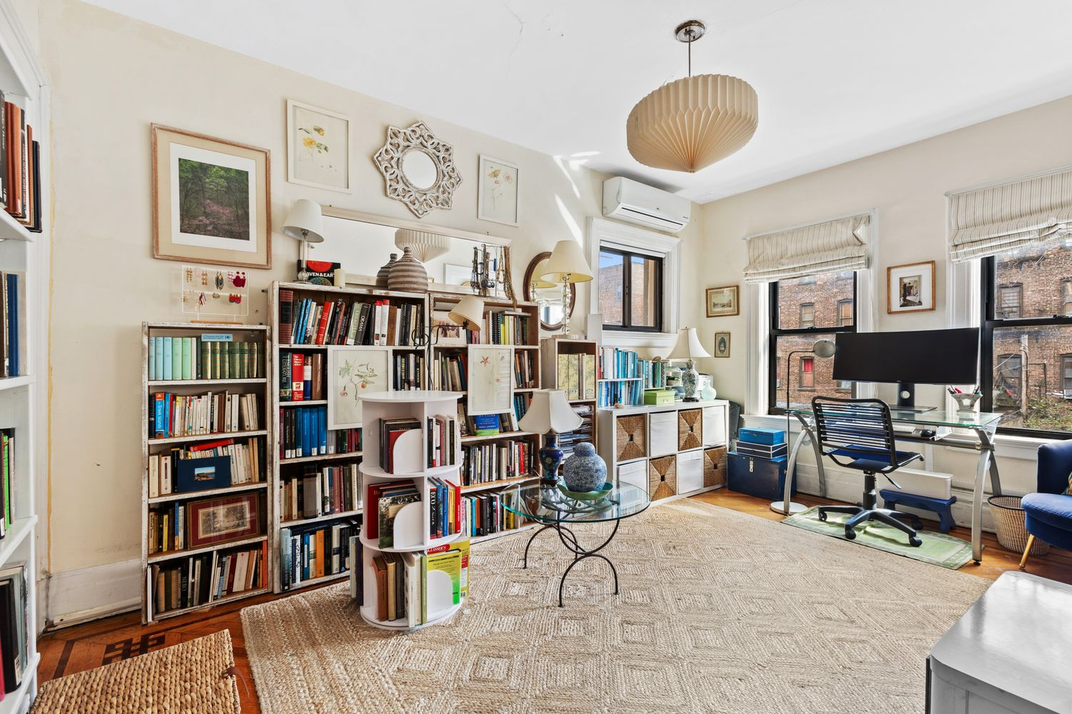 bedroom set up as an office with two exposures, wood floor