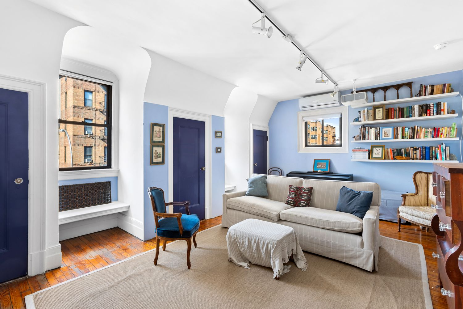 bedroom with blue and white walls, three closets