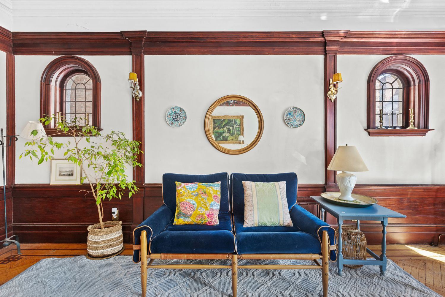 rear parlor with wainscoting, arched windows, moldings