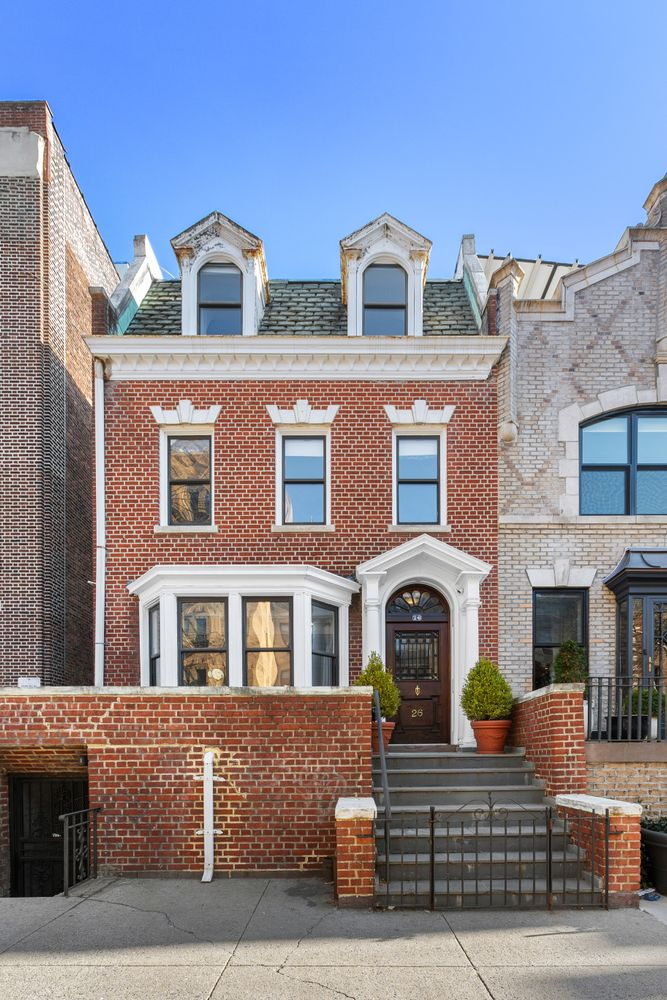 red brick house exterior with dormers