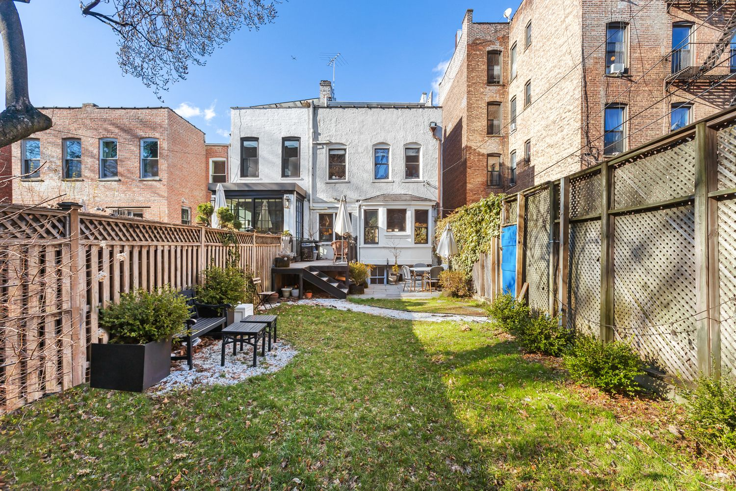 rear yard with a deck, patio and lawn