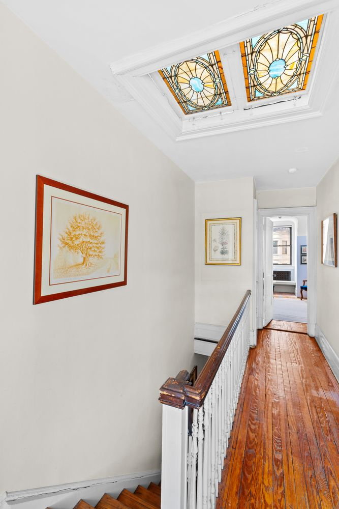 upstairs hall with stained glass skylights