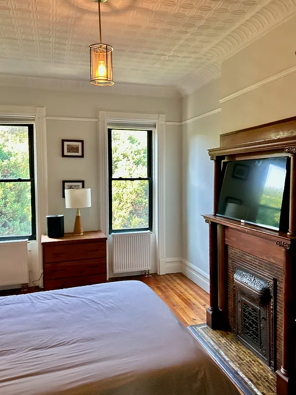 bedroom with a wood mantel