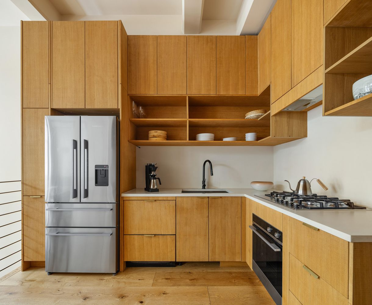 kitchen with slab front, wood cabinets, open shelving
