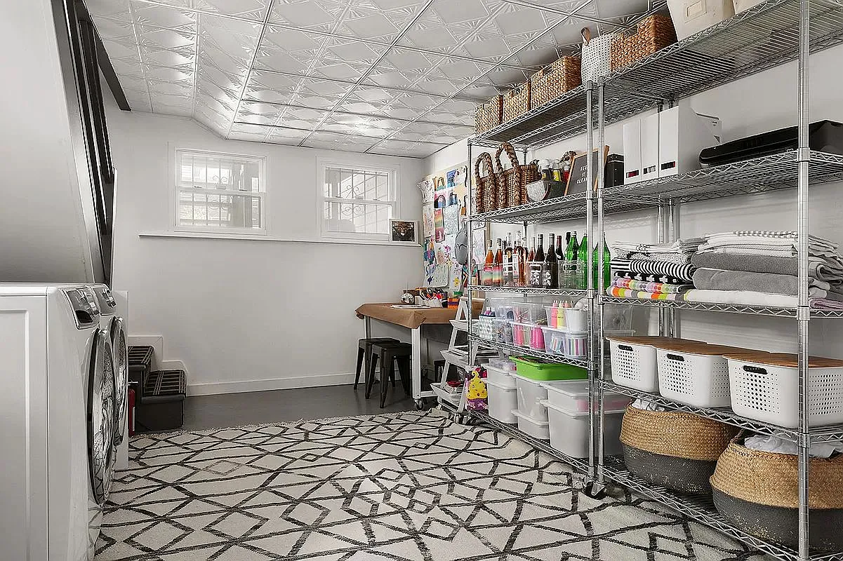 laundry room with full-sized machines, shelving units