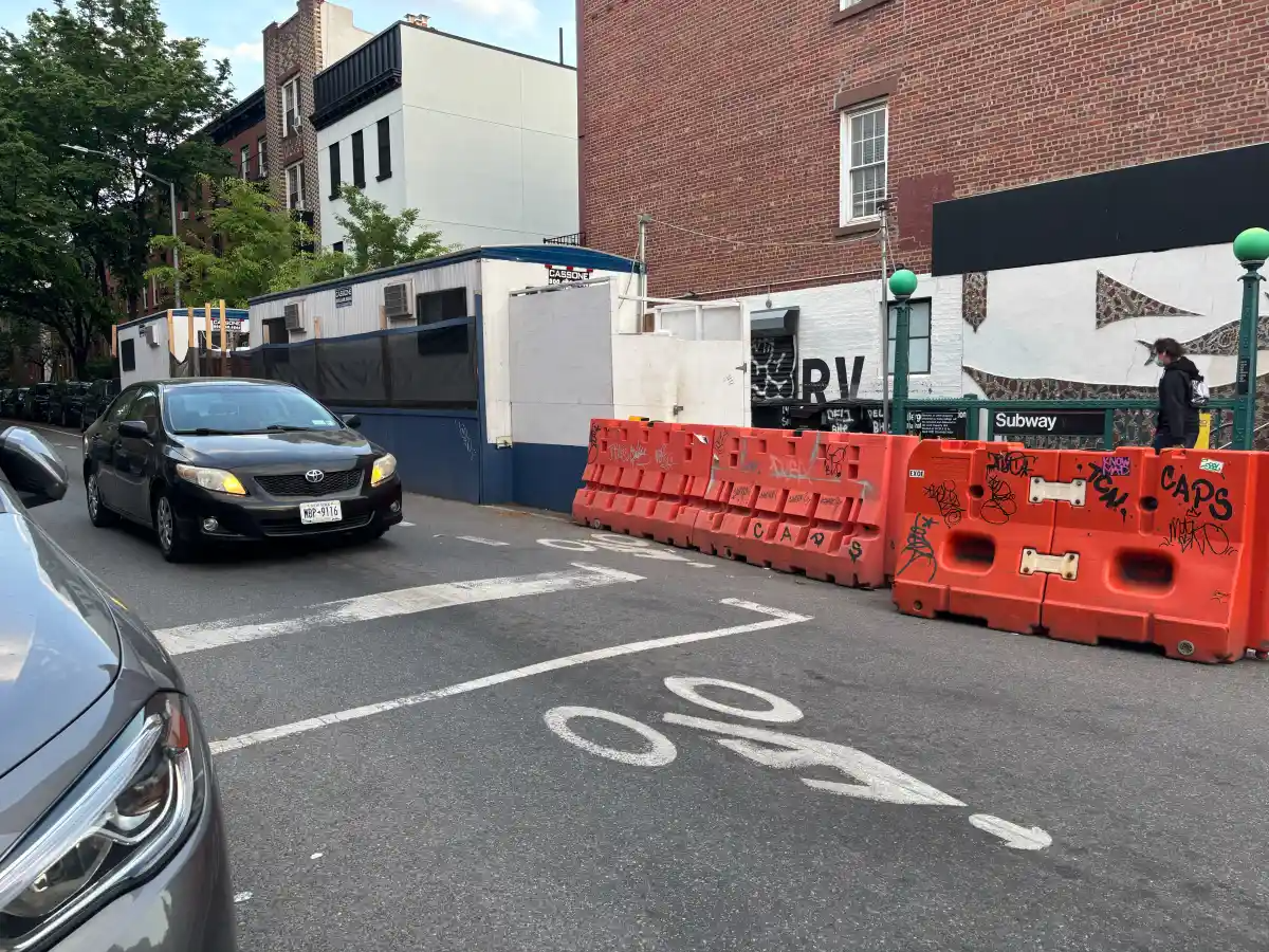 a car on bergen street with a bike lane sign on the street