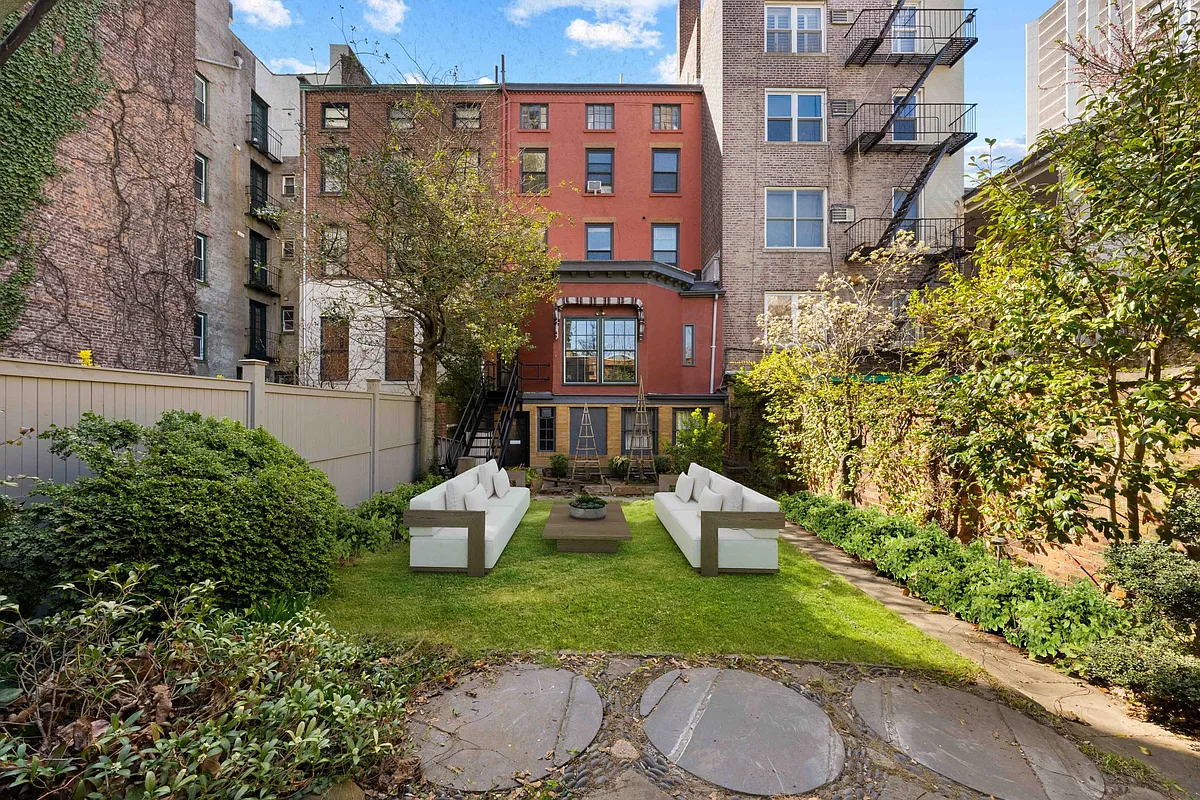 rear yard with virtually staged furniture, rear view of brick row house